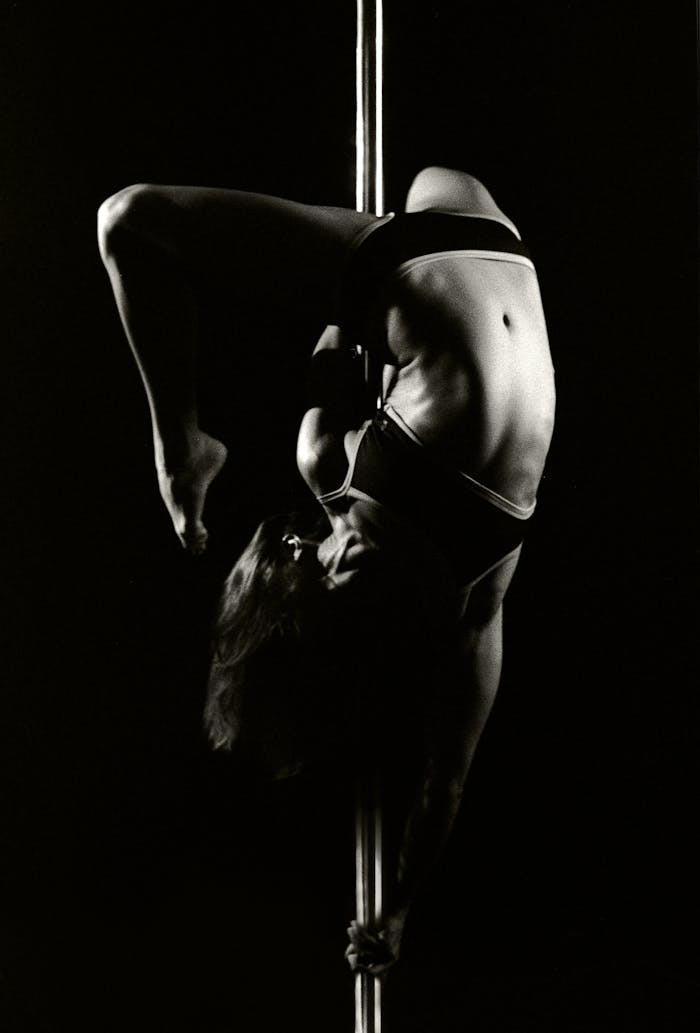 Grayscale Photography of Woman Doing Pole Dancing